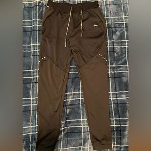 The Nike Dri-FIT pants with sweat-wicking technology. Size M.